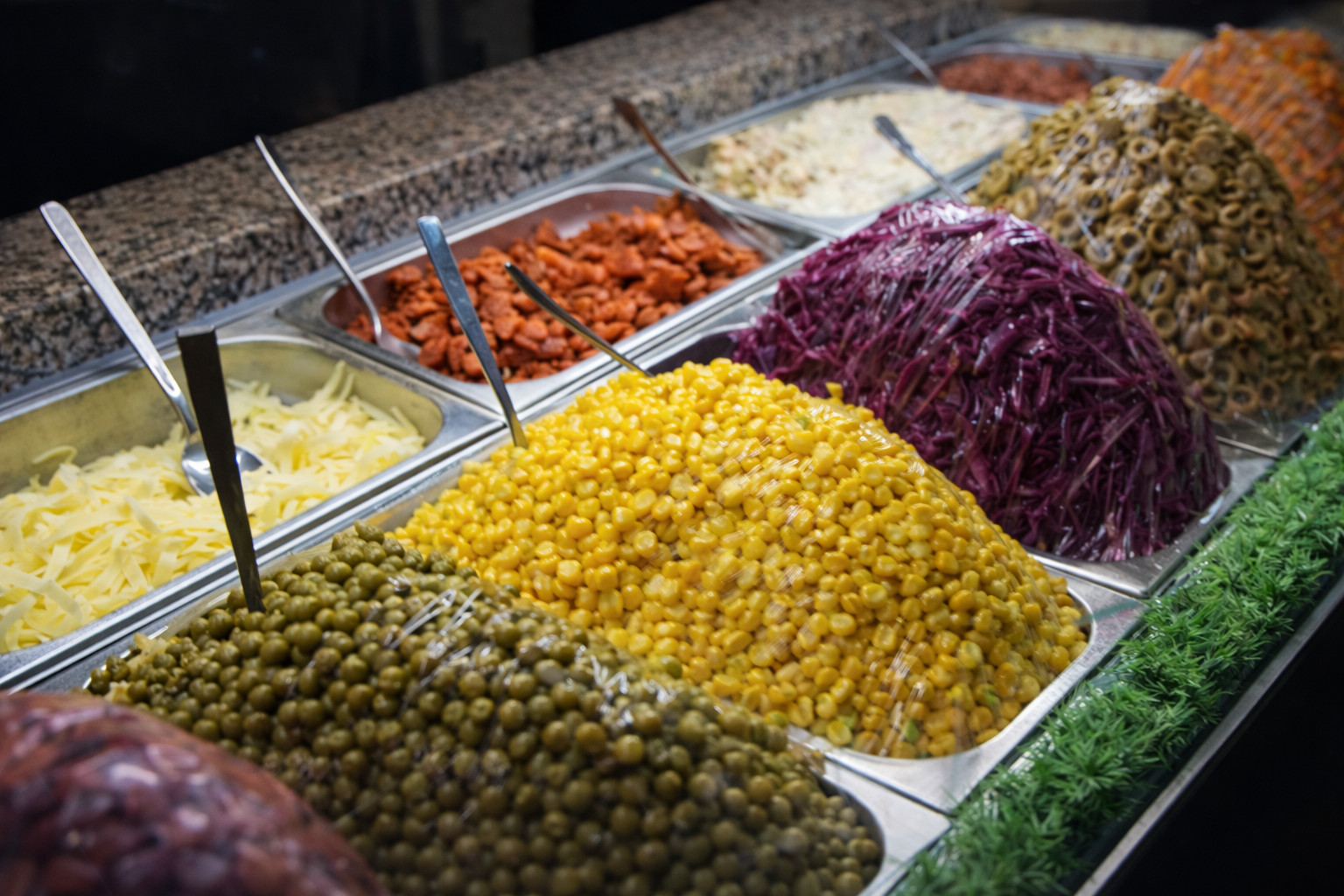 Kumpir stand with colorful fresh toppings ready to customize your loaded baked potato